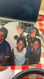 Children from the OneHope International family smiling and waving together